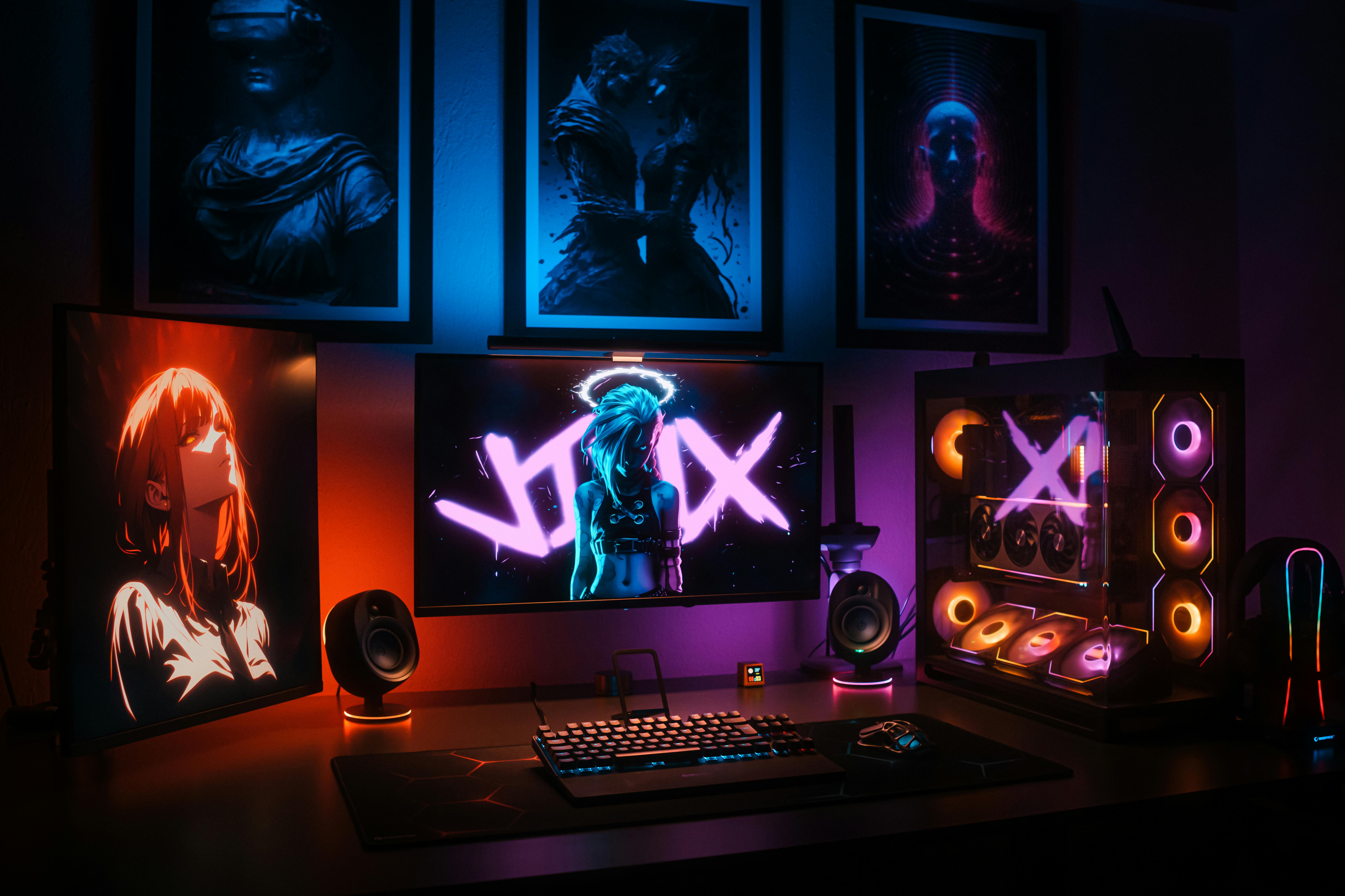 A vibrant gaming setup with neon lights, displays, and a custom PC in an artistic room.
